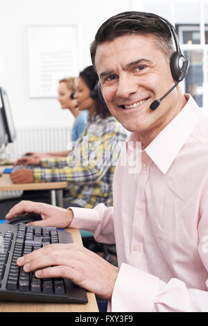 Male Customer Services Agent In Call Centre Stock Photo