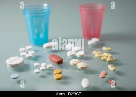 Pills and dispenser cups horizontal Stock Photo