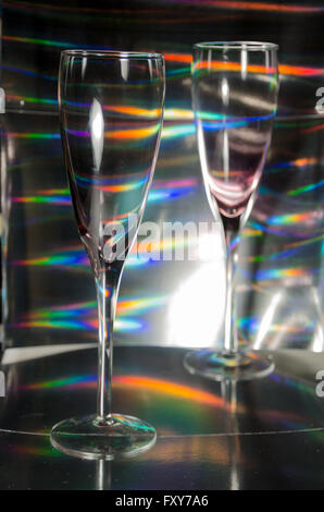 A Studio Photograph of Two Champagne Flutes Set Against a Silver Holographic Backdrop Stock Photo