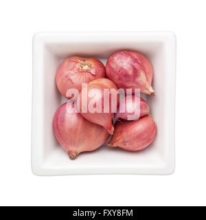 Shallots in a square bowl isolated on white background Stock Photo