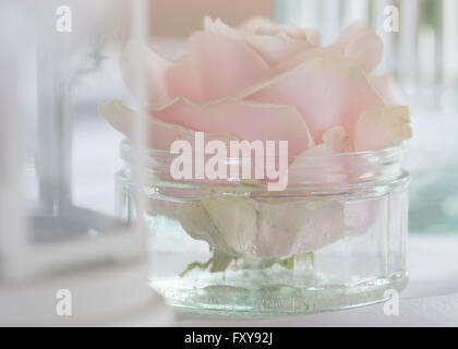 pale pastel pink rose in glass jar boho vintage wedding flowers table arrangements Stock Photo