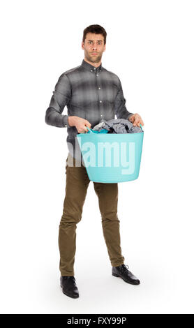 Full length portrait of a young man holding a laundry basket isolated on white background Stock Photo