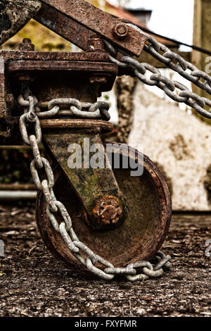 Rusty old metal wheel and chain, UK Stock Photo
