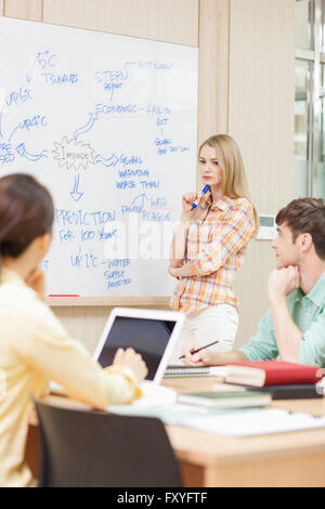 International student in college presenting in front of other students including domestic students in class Stock Photo