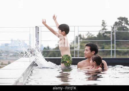 Family having fun at the outdoor spa in hotel Stock Photo