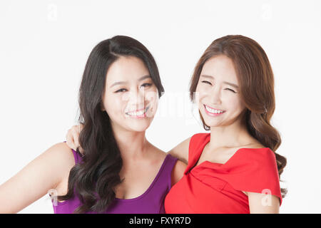 Portrait of two young smiling women staring at front Stock Photo