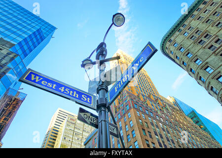 Road signs West 45th St and Fifth Ave in Midtown Manhattan in New York, USA. Skyscrapers are on the background. Stock Photo