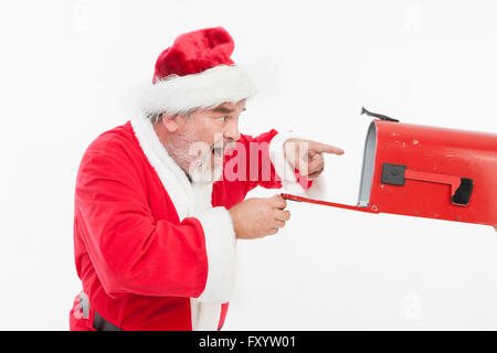 Side view portrait of surprised Santa Claus looking in mail box Stock Photo