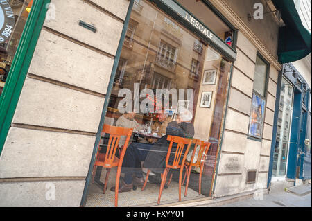 Paris cafe bar, a trio of older Parisians enjoy a chat over coffee in a cafe on the Ile St-Louis in the centre of Paris, France. Stock Photo