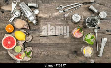 Fruit drinks with ice. Cocktail making bar tools, shaker, glasses. Flat lay. Stock Photo