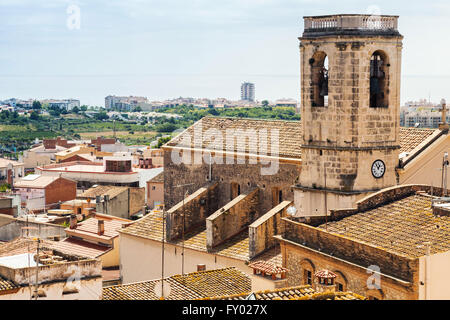 Cityscape of Spanish resort town Calafell in summer. Bell tower and red tiling roofs in old part of town Stock Photo
