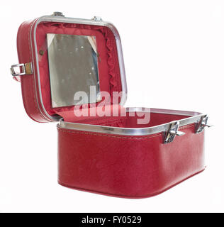 An old vintage red train case or makeup luggage isolated over white background Stock Photo