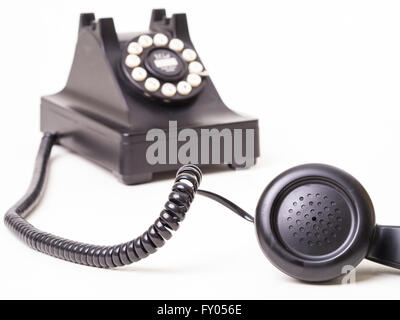Old fashioned telephone with receiver off the hook. Stock Photo