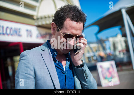 a man talking on his mobile phone on a sunny day Stock Photo