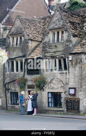 Bradford on Avon The Bridge Tea Room traditional Victorian Waitress in traditional dress taking card payment on machine outside Stock Photo