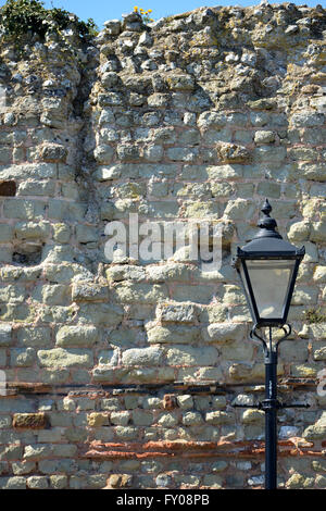 Old street lamp next to ancient wall, Pevensey, UK Stock Photo
