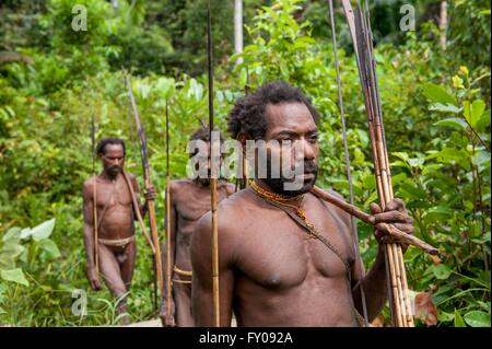The group Portrait Korowai people on the natural green forest background Stock Photo