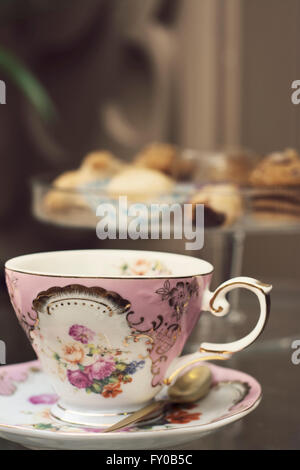 Antique porcelain mug, decorated with pink bouquet Stock Photo