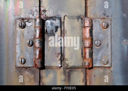 Closeup photograph of a pair of old rusty hinges from the engine bay of a 1940's American made  locomotive. Stock Photo