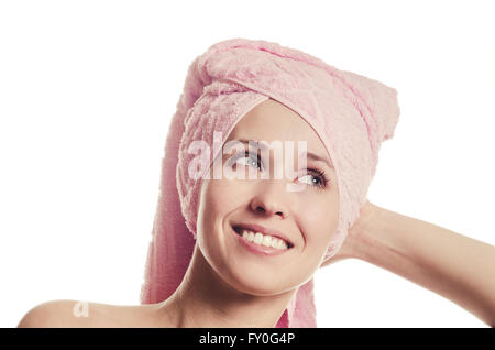 The woman with a towel on the head smiles with teeth Stock Photo