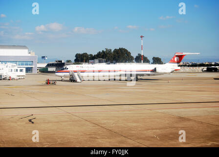 Cagliari, Italy - January 24, 2010: Meridiana Airplane in the airport at Cagliari. Land and daytime as editorial Stock Photo