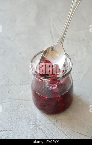 Raspberry jam close up in a glass jar Stock Photo