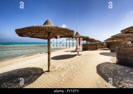 Marsa Alam beach with row of umbrella, Egypt Stock Photo