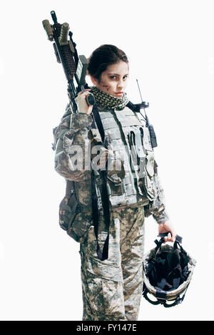 Army soldier carrying rifle and helmet standing against white background Stock Photo