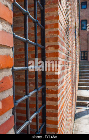 Barred window on a brick wall Stock Photo
