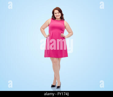 happy young plus size woman posing in pink dress Stock Photo