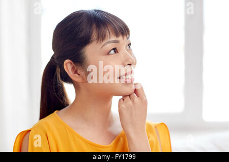 happy asian young dreaming woman face at home Stock Photo