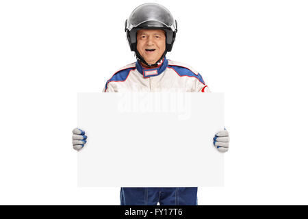 Mature car racer in a racing suit and a helmet holding a blank signboard isolated on white background Stock Photo