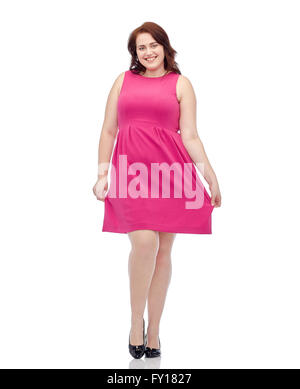 happy young plus size woman posing in pink dress Stock Photo