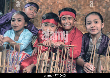 Sundanese children play traditional music instruments called angklung ...