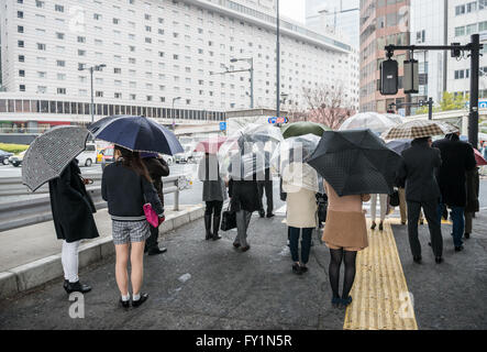People with umbrellas at Sotobori Street in Tokyo city, Japan Stock Photo