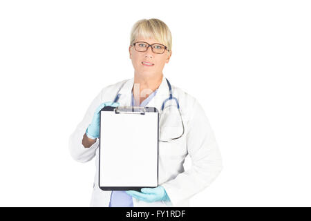 Mature nurse with blank clipboard on white. Model is an actual nurse and her recognizable photos are exclusive to Alamy. Stock Photo