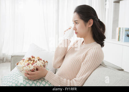 Side view portrait of young woman wiping her tears Stock Photo