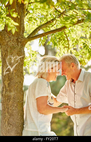 Happy senior couple in love flirting and looking each other in the eyes Stock Photo