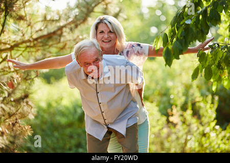 Senior couple doing piggyback having fun Stock Photo