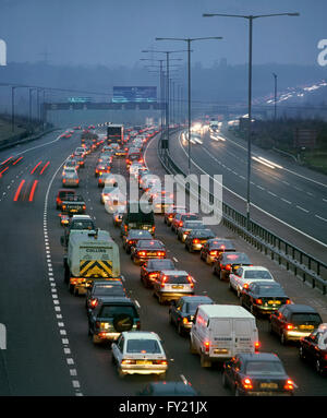 Winter rush hour traffic on the M25 almost at a standstill. Looking north towards junction 16 with the M40 near Uxbridge. Stock Photo
