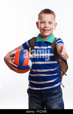 Happy schoolboy with backpack and soccer ball isolated on white background Stock Photo