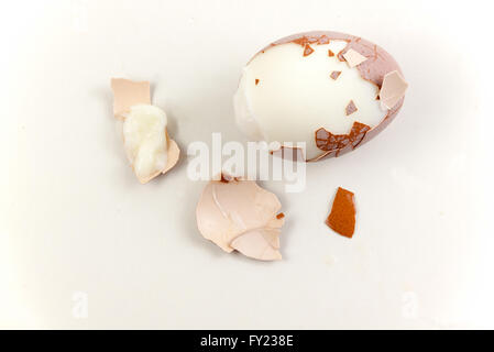 peeled boiled egg on white background. Flat Lay in food. Stock Photo