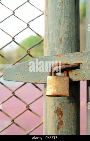 Old bolt and padlock on the door tennis court Stock Photo