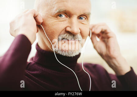 Senior man with earphones Stock Photo