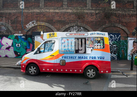 A colourful ice cream van in Shoreditch in front of some murals Stock Photo