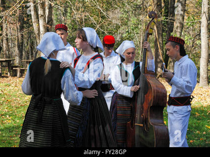 People playing folk instruments dresses in traditional costume on Plitvice lakes in Croatia Stock Photo