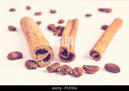 Close up of cinnamon sticks and coffee beans in blurred background. Stock Photo