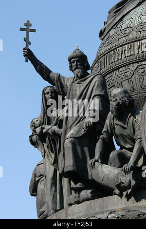 Grand Prince Vladimir the Great. Detail of the Monument to the Millennium of Russia (1862) designed by Russian sculptor Mikhail Mikeshin in Veliky Novgorod, Russia. The statue of Prince Vladimir the Great represents the Christianization of Kievan Rus (988). Vladimir the Great is depicted raising an Orthodox cross. Besides him a woman holds her child for baptism and a Slav dispossesses the pagan god Perun. Stock Photo