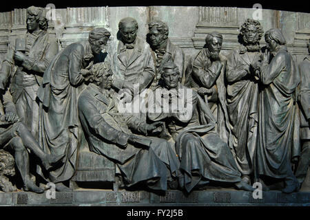 Russian writers and artists depicted in the bas relief by Russian sculptor Ivan Schroder. Detail of the Monument to the Millennium of Russia (1862) designed by Mikhail Mikeshin in Veliky Novgorod, Russia. Persons from left to right: actor Fyodor Volkov, playwright and historian Nikolay Karamzin, poet and fabulist Ivan Krylov (sitting), poet and translator Vasily Zhukovsky, poet and translator Nikolay Gnedich, writer and diplomat Alexander Griboyedov (sitting), poet and writer Mikhail Lermontov, poet and writer Alexander Pushkin, novelist and writer Nikolai Gogol. Stock Photo