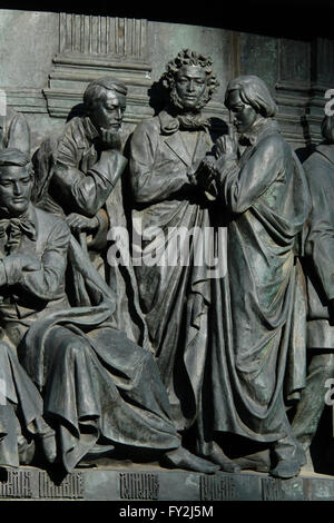 Russian poet and writer Mikhail Lermontov, Russian poet and writer Alexander Pushkin and Russian novelist and writer Nikolai Gogol depicted (from left to right) in the bas relief dedicated to Russian writers and artists by Russian sculptor Ivan Schroder. Detail of the Monument to the Millennium of Russia (1862) designed by Mikhail Mikeshin in Veliky Novgorod, Russia. Russian writer and diplomat Alexander Griboyedov is depicted sitting in the foreground in the left. Stock Photo